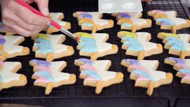 Step by step. Painting food glitter on top of unicorn sugar cookies with royal icing.
