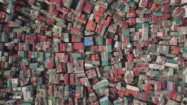 Drone Top view of roof houses beautiful abstract pattern. Densely populated area low-rise buildings map. Narrow slum streets. Asia. Unique urban landscape. High density spontaneous. Aerial