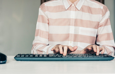 Close-up of hands woman typing on keyboard computer on white table, business concept.