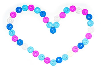 Heart shape of their multi-colored buttons on a white background. Isolate, Flat Lay, Copy space