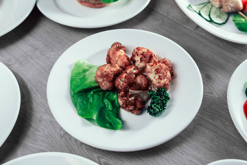 Baked cauliflower in breadcrumbs on a white plate