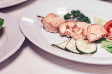 barbecue on a wooden skewer with fresh vegetables