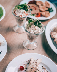 chicken salad with fresh vegetables in serving glasses on the festive table
