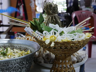 Selective focus of Cape Jasmine flowers ( Dok put ) with holy white thread ( Sai sin ) for Rod Nam Dam Hua ceremony, paying respect to the elders, during Songkran festival in Thailand