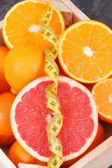 Fototapeta na wymiar Fresh orange, grapefruit and mandarins in wooden box. Fruits as source minerals and vitamins