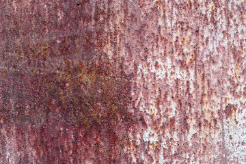 The old rusty surface of metal damaged by bad weather. Spots and smudges of paint. Ready photo background. Macro.