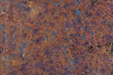 The old rusty surface of metal damaged by bad weather. Spots and smudges of paint. Ready photo background. Macro.
