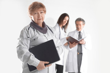 female doctor therapist with laptop on blurred background of colleagues
