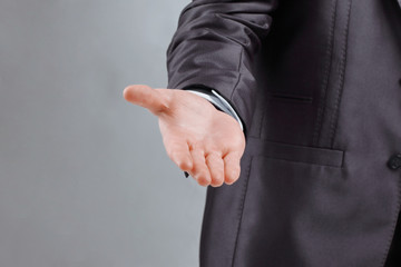 close up. the businessman reaches out to the partner .isolated on grey background