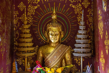 The Buddha inside a tiny room for worship in the temple.