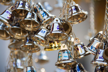 Muang, Phrae, Thailand - February 9, 2019: Many silver small bells hanging in the temple to pray for famous reputation like the sound of the bell.