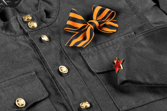 orange symbol of george ribbon on black and white military uniform, close-up