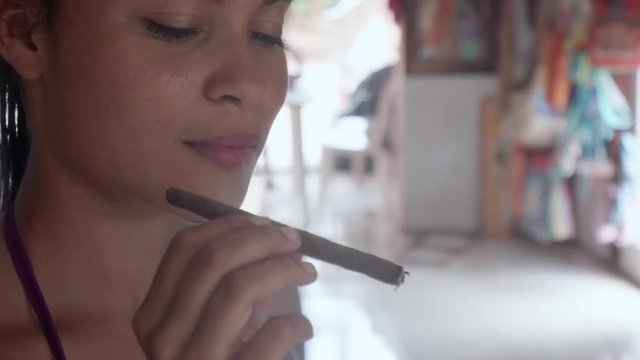 Slow Motion: Beautiful Young Woman Smoking Cigarillo in El Limon, Dominican Republic