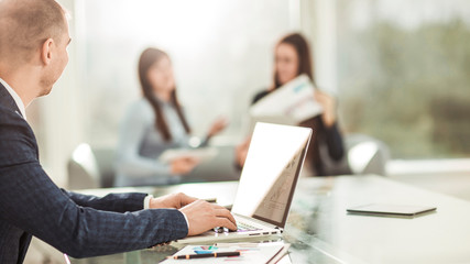 financial managers working on laptop with financial data at the workplace in a modern office