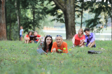 group of student couples preparing for exams in the city Park