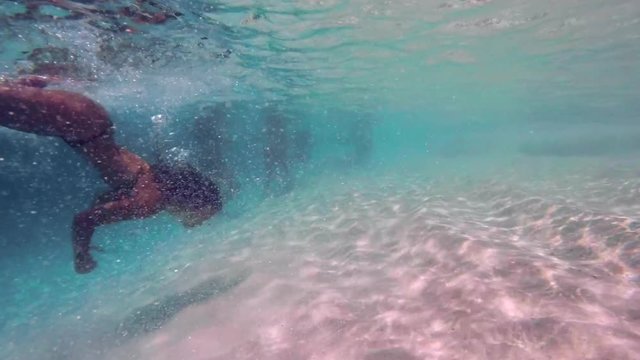 Slow Motion: Young Woman in Bikini Swimming Underwater in Shallow Ocean in El Limon, Dominican Republic
