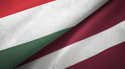 Hungary and Latvia two flags textile cloth, fabric texture