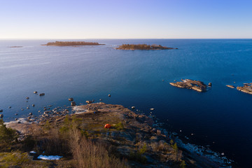 Orange tent on the shore of the Baltic Sea. Spring morning View from above