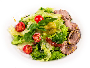 Roast beef salad with tomatoes, and pepper in white plate isolated on white background