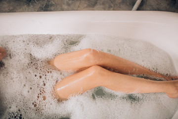 Beautiful sexy woman in bubble bathtub