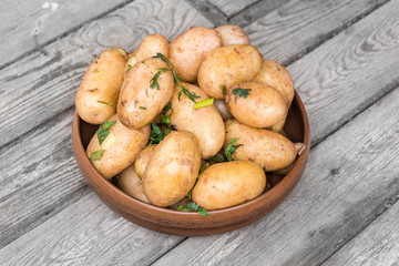 Delicious hot baked potatoes in rustic plate