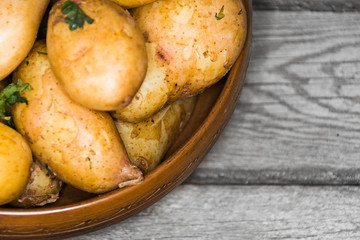 Delicious hot baked potatoes in rustic plate