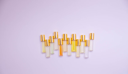 perfume glass tester vials of different kinds on light background. Perfume testers for scent recognition. perfume sample.