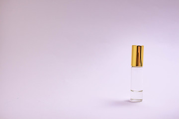 Perfume tester. Small perfume glass bottle with gold cap. Space text. The concept of minimalism. mockup.