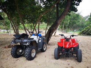 Fototapeta na wymiar Bike sport and ATV sport recreation activities on sandy beach
