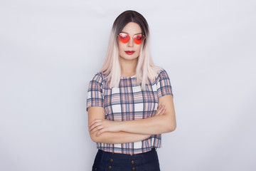 Blonde woman wearing sunglasses over white background