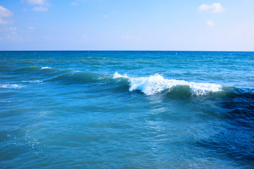 Beautiful view of splashing blue waves near the beach.