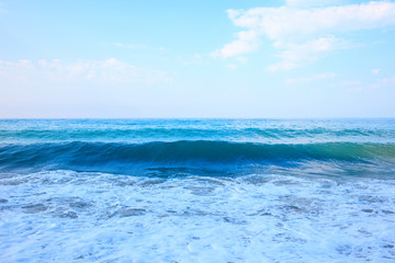 Beautiful view of splashing blue waves near the beach.