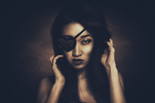 Portrait of beautiful woman with heart shape eye patch