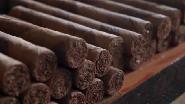 Slow Motion: Close-Up of Row of Stacked Cigars in El Limon, Dominican Republic
