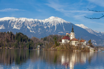 Lake Bled against snowy mountain peaks in early spring. Slovenia, Europe