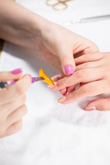 Obraz na płótnie Canvas Closeup view of hands with manicure of young woman Nail treatment by a specialist in the salon