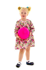 Little girl is playing with a ball