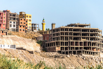Fototapeta premium Aswan city Egypt panorama view from a boat on the west coast of the Nile on a sunny day