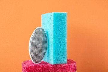 pumice and blue washcloth on a trending orange background, the concept of cleanliness and body care