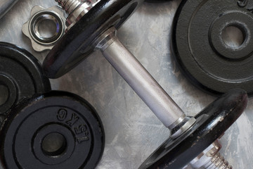 Fitness or bodybuilding concept background. Product photograph of old iron dumbbells on grey,...