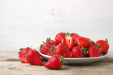 Fresh strawberries in plate on wood - 263631144
