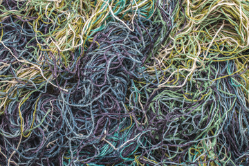 background of colored threads chaotically intertwined. green yellow and brown threads matted in a colorful background