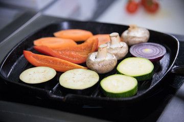 Heating up the mushrooms and vegetables in the pan without an oil