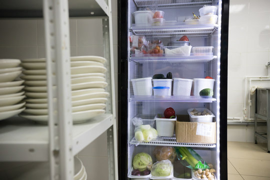 Restaurant Kitchen. An Opened Fridge With Products