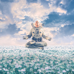 Dreamer in the field / 3D illustration of surreal science fiction scene with meditating astronaut levitating over a field of flowers under a glorious sky