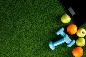 Sport equipment. Creative flat lay of sport and fitness equipment on green grass. View from above. Flat lay. Copy space.