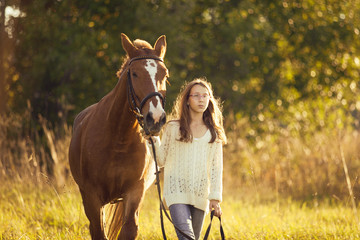 Fototapeta premium Young girl with horse in field