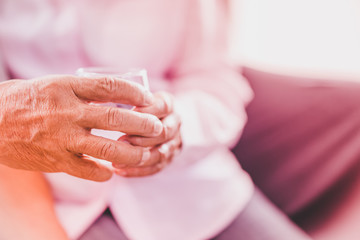 senior asian couples take pill with glass of water, selective focus