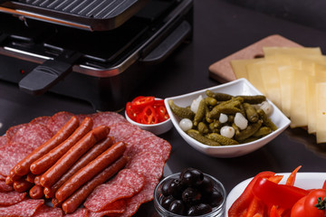 young woman is preparing a traditional Swiss cheese raclette