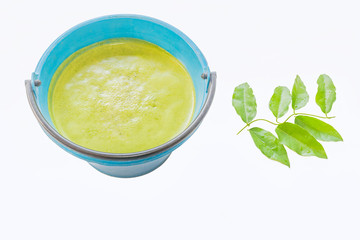 Bamboo grass ,Tiliacora triandra ,Menispermaceae ,leaf Juice in the container and Bamboo grass leaves with the white background.